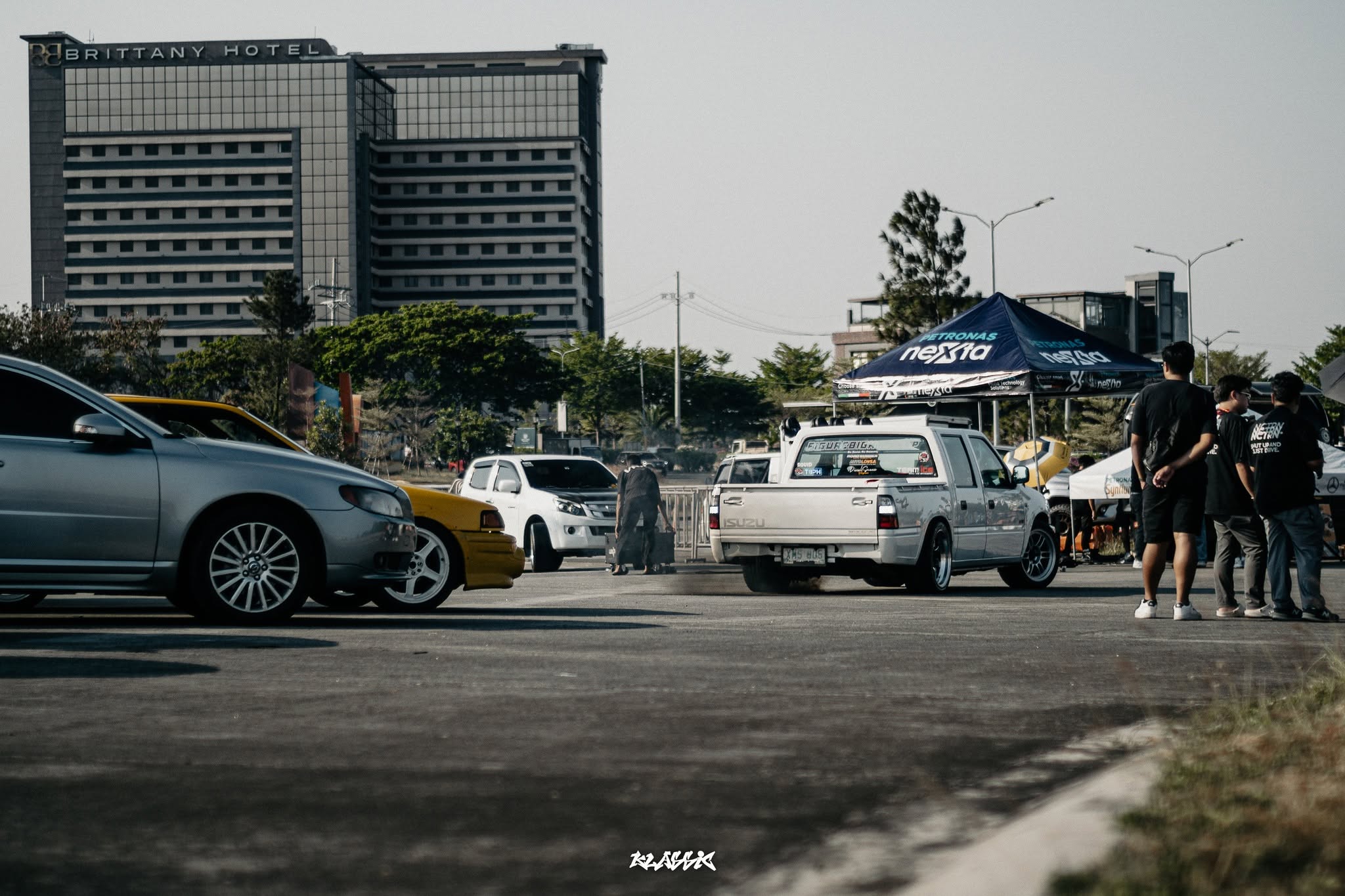 A driver arriving solo at an open car meet